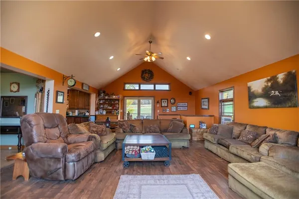 a view of a hallway with wooden floor and furniture