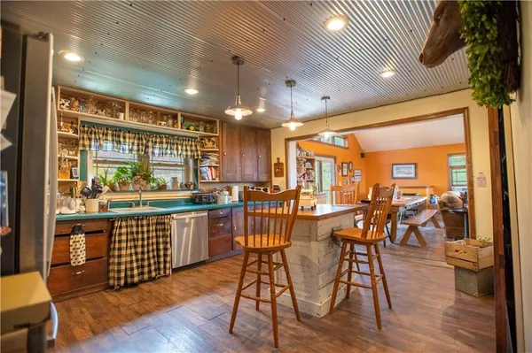 a view of a dining room with furniture and a chandelier