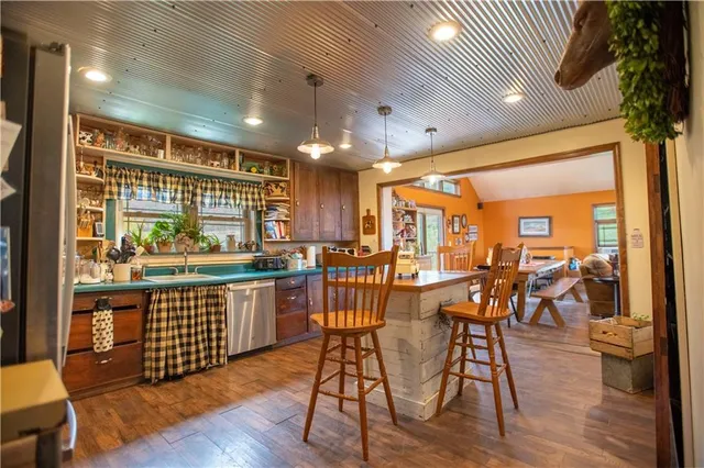 a view of a dining room with furniture and a chandelier