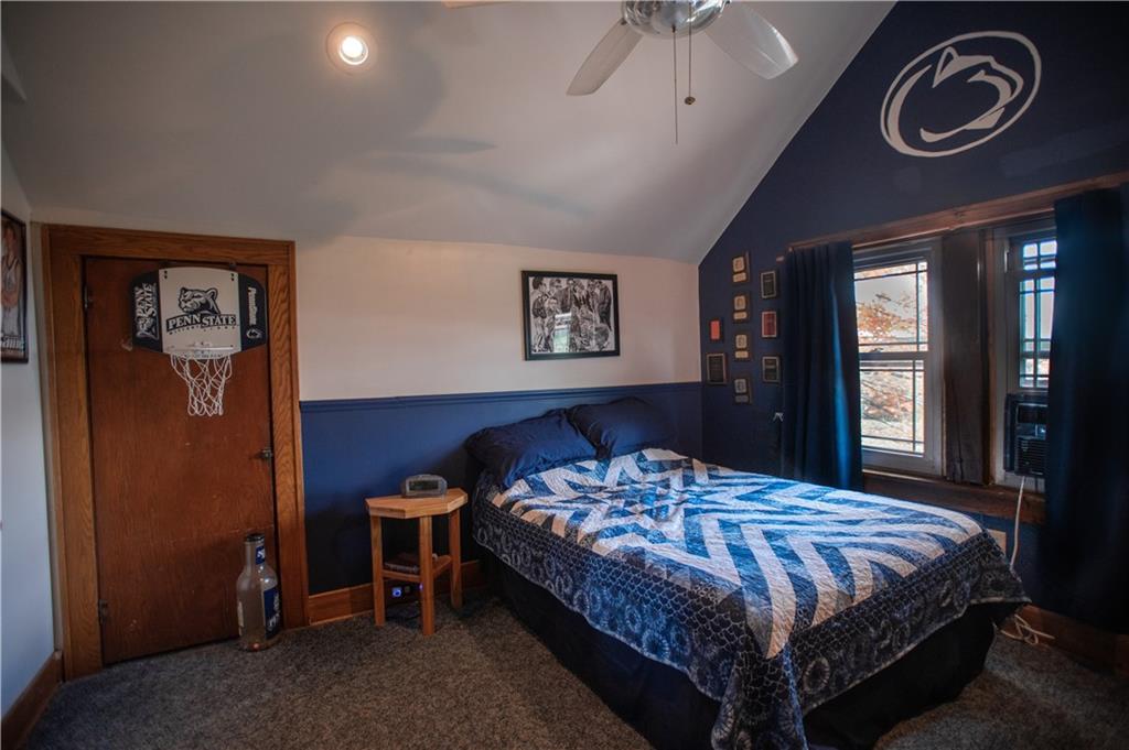 702 Keister Road Venus, PA 16364 - Photo 20 of 39 a bedroom with a bed and a chandelier