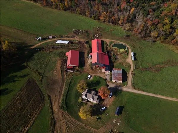 an aerial view of a house swimming pool a yard and mountain view