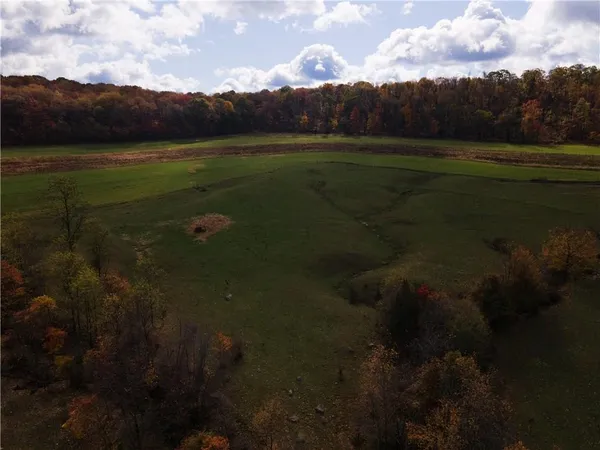 an aerial view of a house with a yard table and chairs
