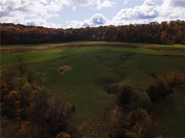 an aerial view of a house with a yard table and chairs