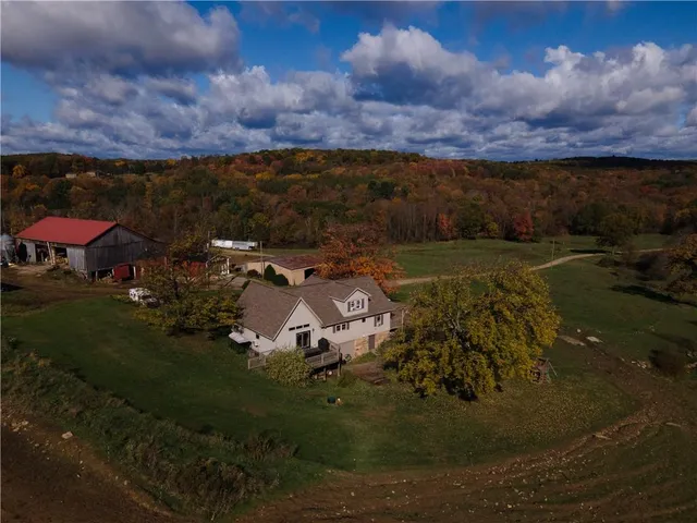 an aerial view of a house with a yard