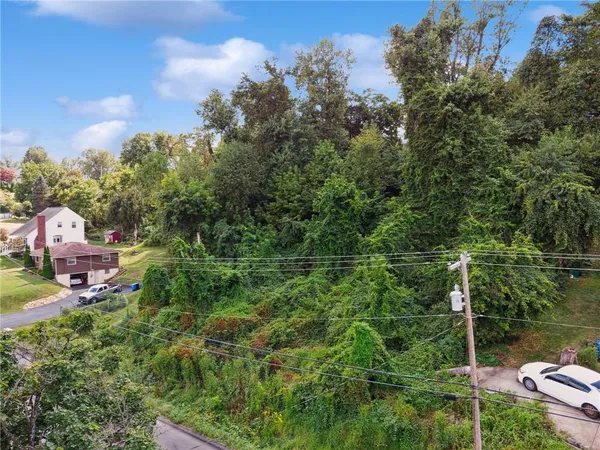 an aerial view of a house with outdoor space and street view