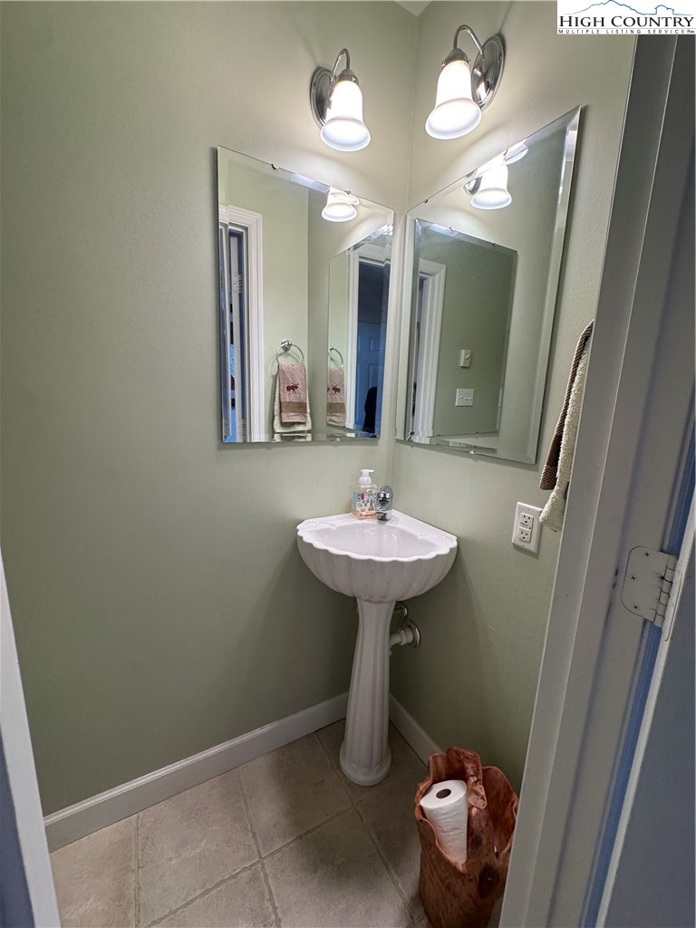 128 Hillcrest Road Newland, NC 28657 - Photo 8 of 37 a bathroom with a sink a mirror and vanity