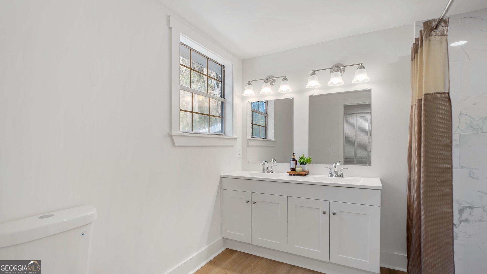 79 Terry Drive Midway, GA 31320 - Photo 11 of 27 a bathroom with a double vanity sink and mirror