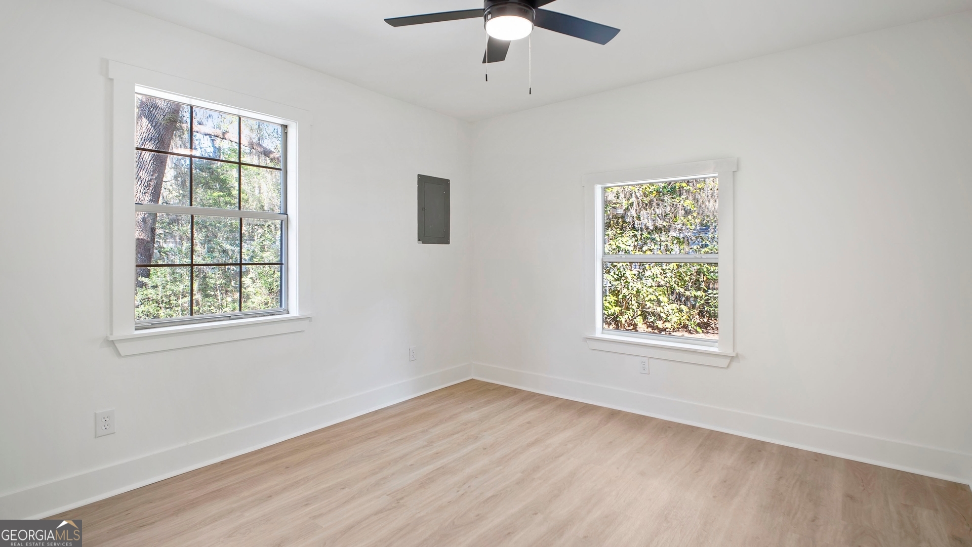 79 Terry Drive Midway, GA 31320 - Photo 17 of 27 a view of an empty room with wooden floor and a window