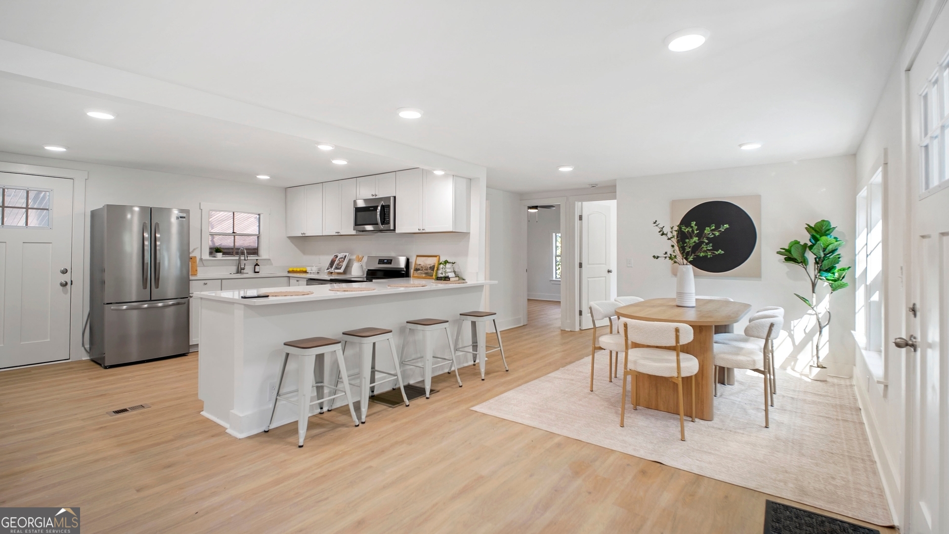 79 Terry Drive Midway, GA 31320 - Photo 2 of 27 a kitchen with stainless steel appliances a table and chairs in it