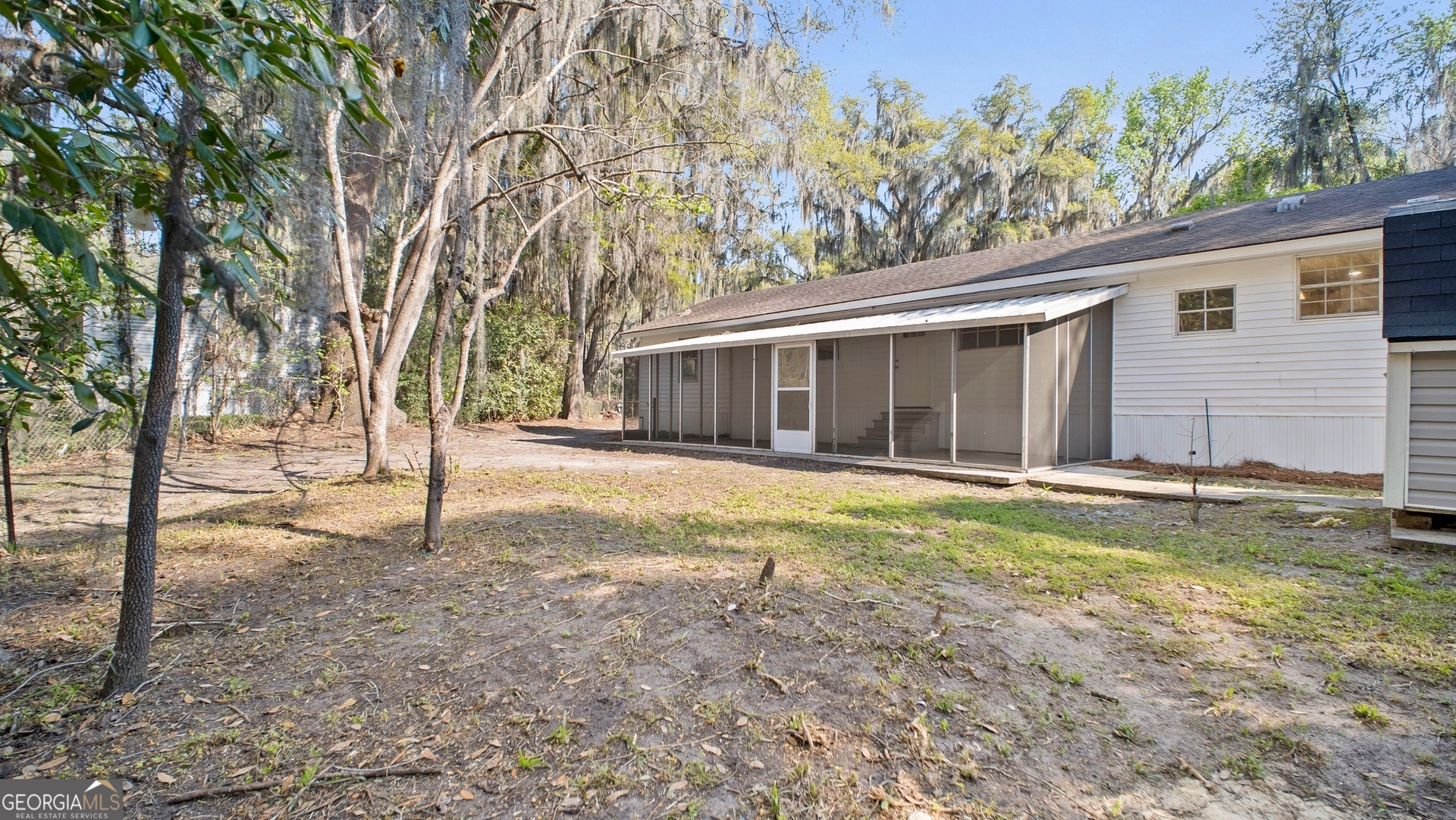 79 Terry Drive Midway, GA 31320 - Photo 22 of 27 a view of a house with a yard and tree s
