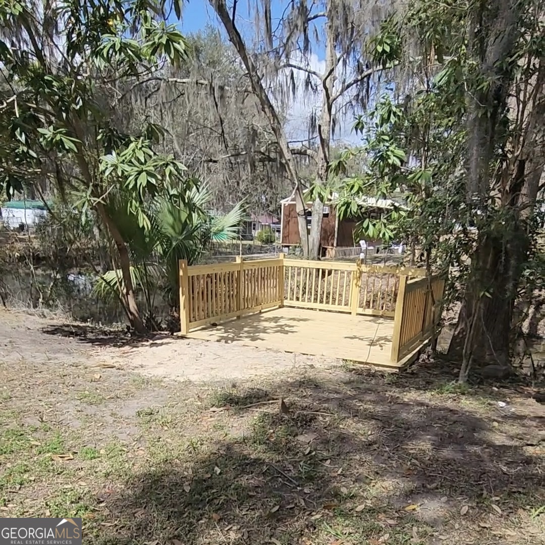 79 Terry Drive Midway, GA 31320 - Photo 24 of 27 a view of a house with large trees and a tree