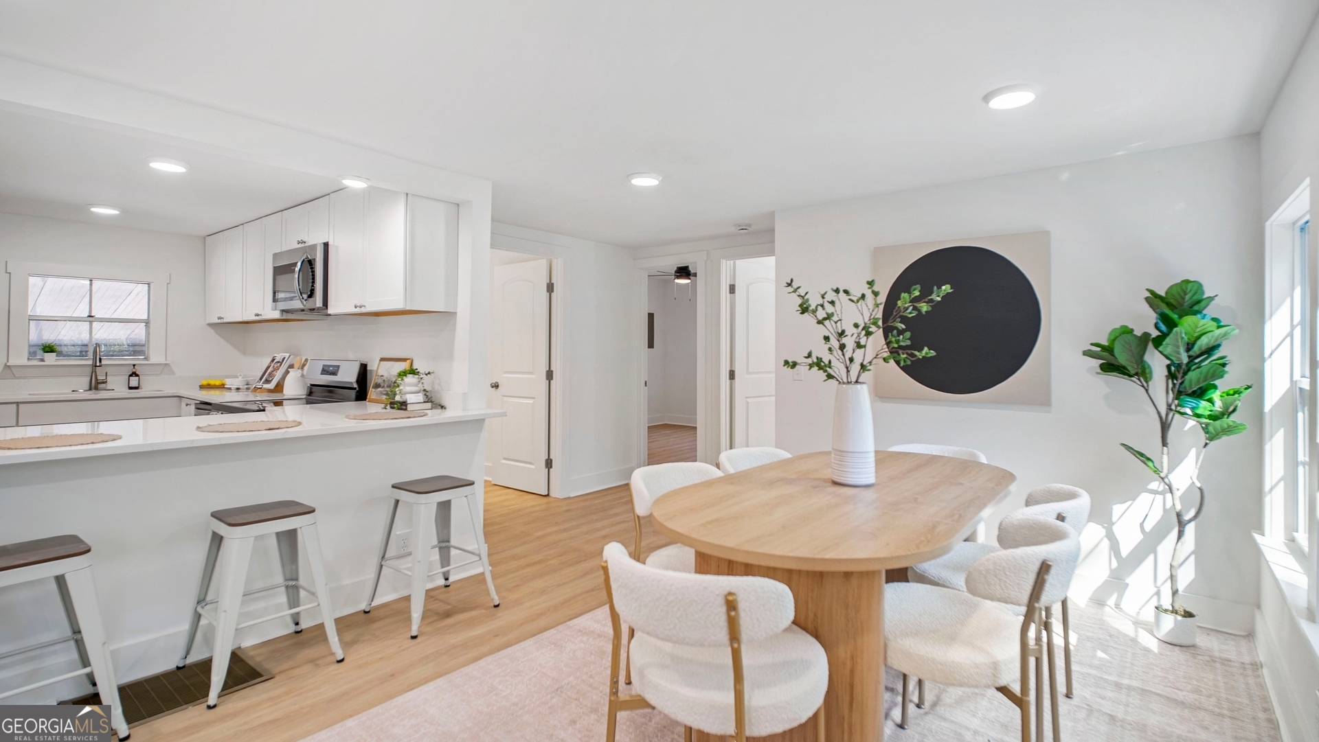 79 Terry Drive Midway, GA 31320 - Photo 6 of 27 a kitchen with stainless steel appliances granite countertop a dining table chairs and a refrigerator