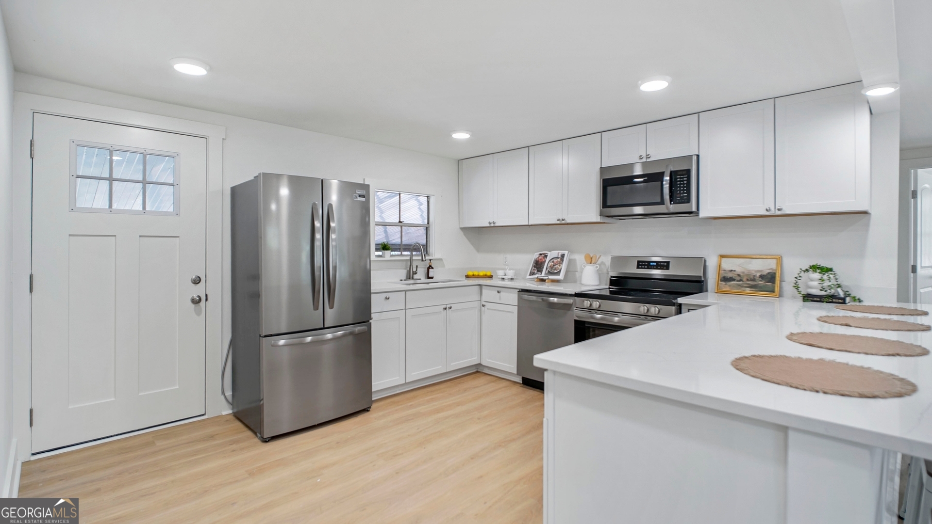 79 Terry Drive Midway, GA 31320 - Photo 7 of 27 a kitchen with stainless steel appliances granite countertop a refrigerator stove microwave and sink