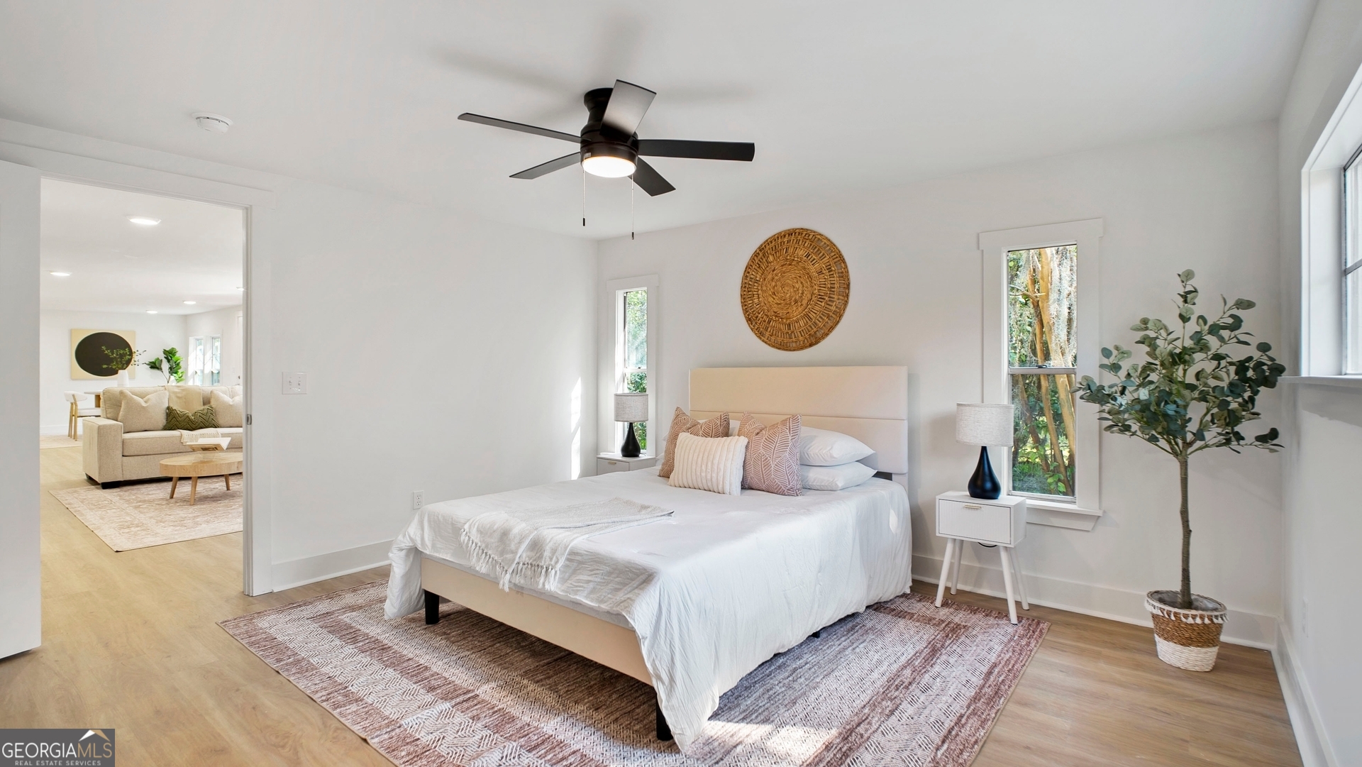 79 Terry Drive Midway, GA 31320 - Photo 9 of 27 a bedroom with a bed and a chandelier