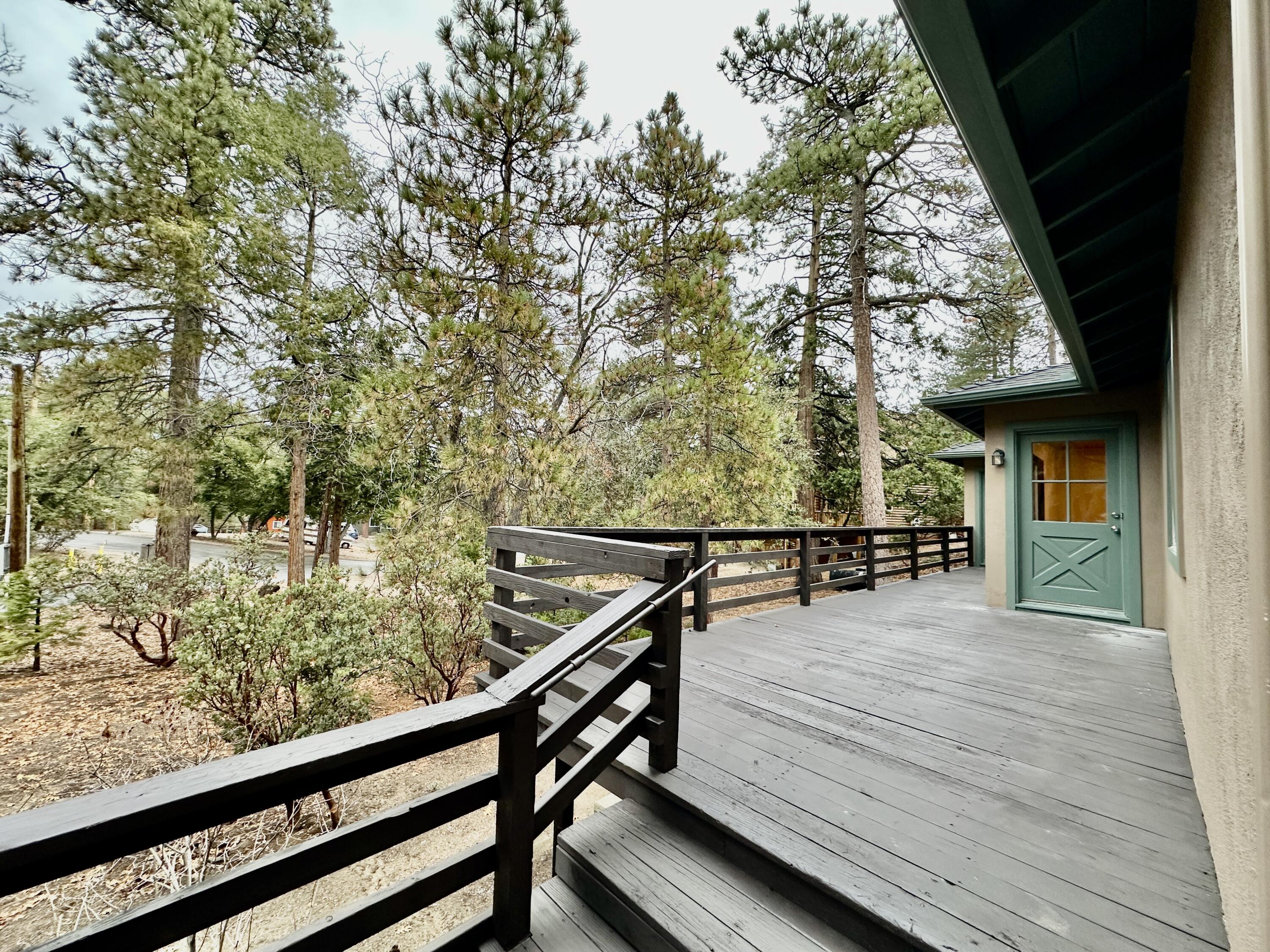 25340 Marion Ridge Drive Idyllwild, CA 92549 - Photo 2 of 31 a view of a chairs and table on the wooden deck