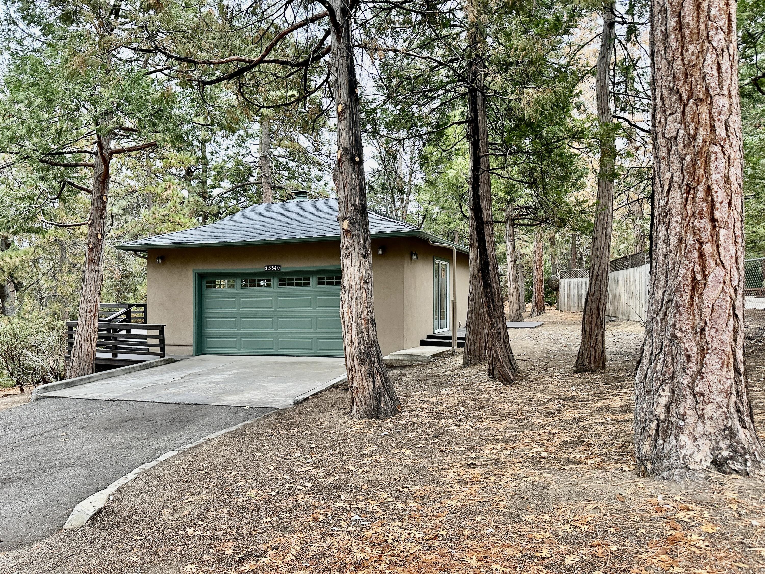 25340 Marion Ridge Drive Idyllwild, CA 92549 - Photo 27 of 31 a view of a house with large trees and a barn