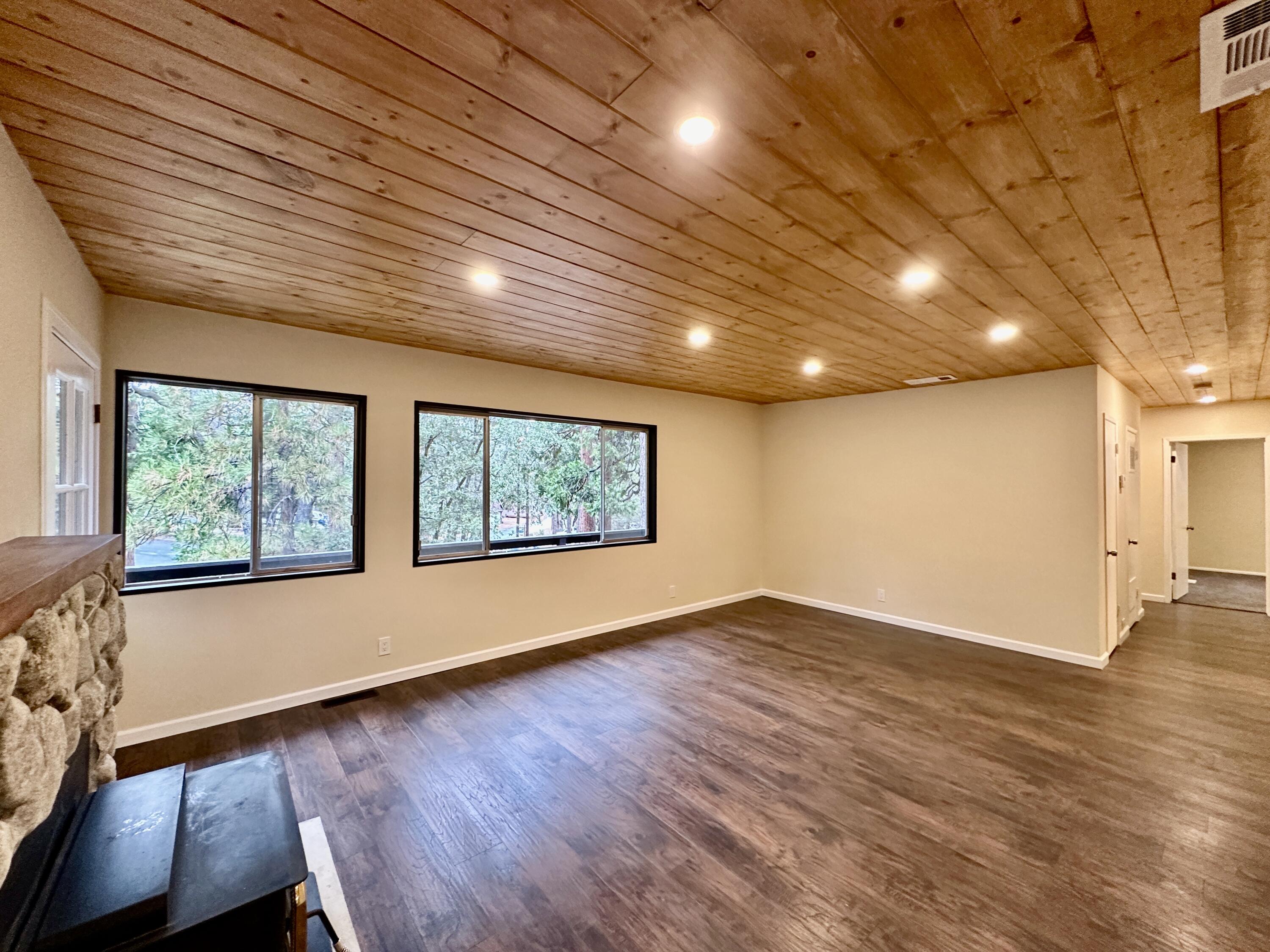 25340 Marion Ridge Drive Idyllwild, CA 92549 - Photo 5 of 31 an empty room with wooden floor and windows