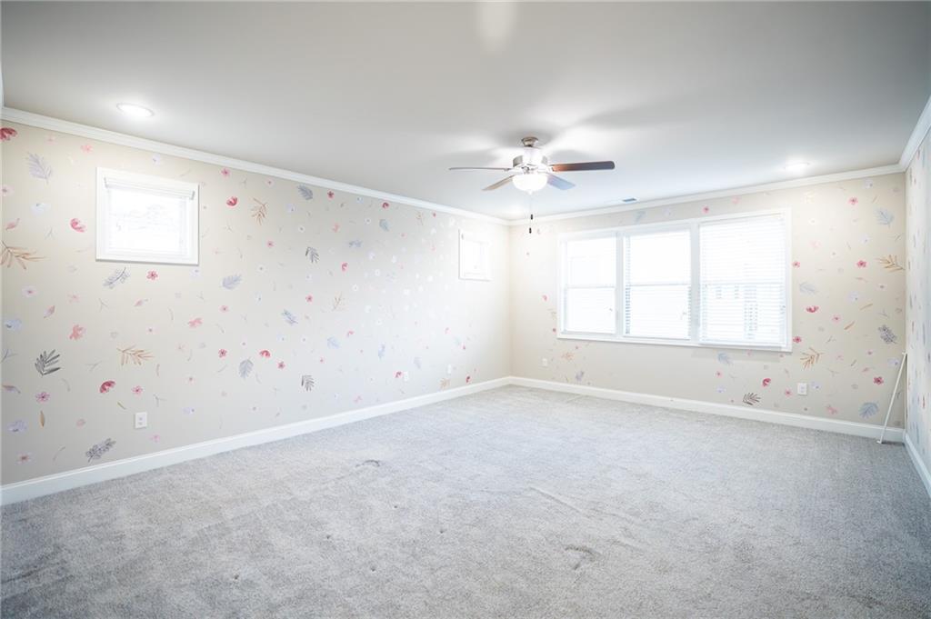 2215 A Manor Pointe Drive Cumming, GA 30041 - Photo 14 of 49 an empty room with a window and a ceiling fan
