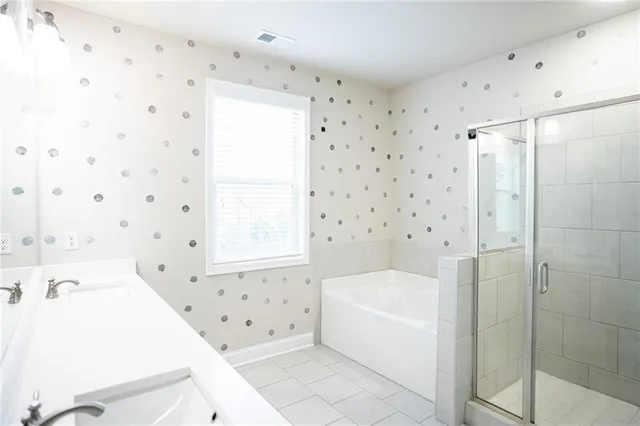 a bathroom with a bathtub and a shower