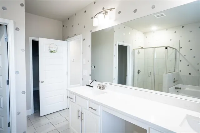a bathroom with a sink vanity and mirror