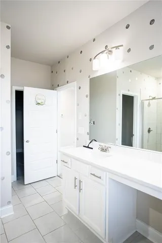 a bathroom with a shower and a sink