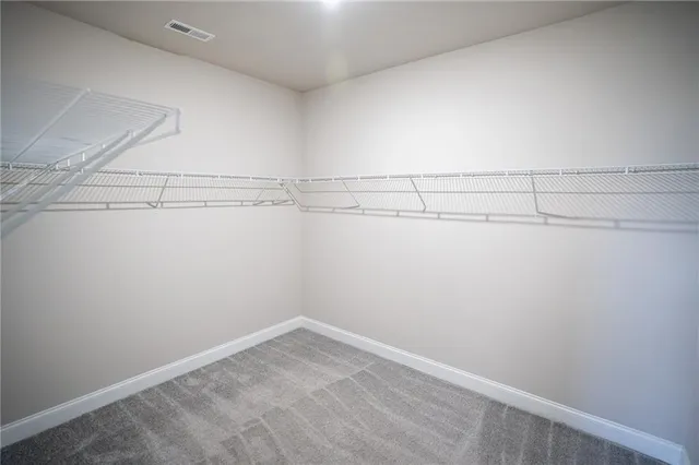 an empty room with wooden floor and a fireplace