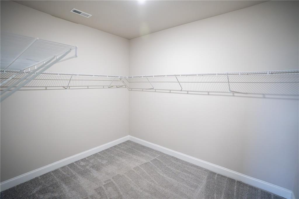 2215 A Manor Pointe Drive Cumming, GA 30041 - Photo 22 of 49 a view of a room with racks on the wall