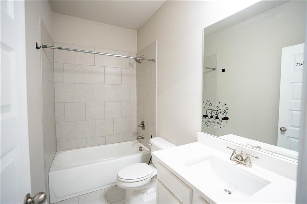 2215 A Manor Pointe Drive Cumming, GA 30041 - Photo 32 of 49 a bathroom with a sink toilet and shower