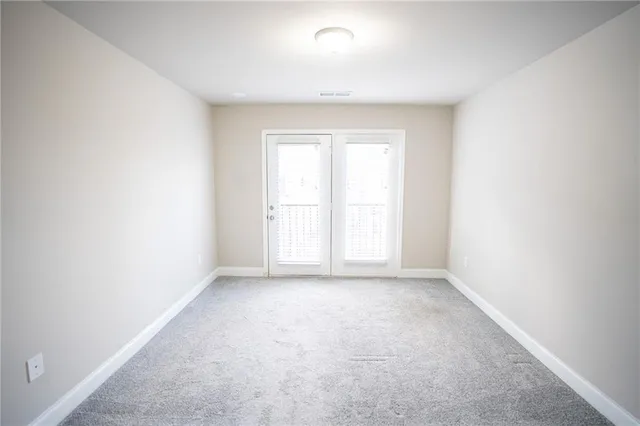 a view of staircase with white walls and a window