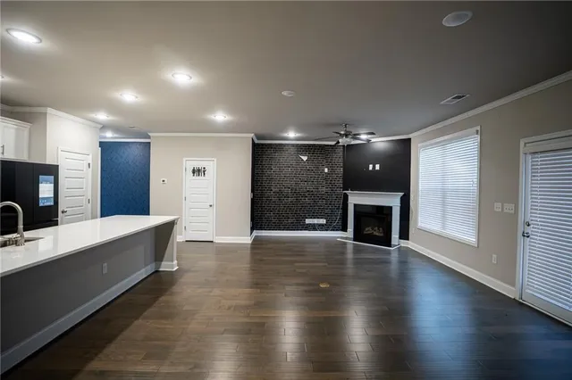 an empty room with wooden floor and fireplace