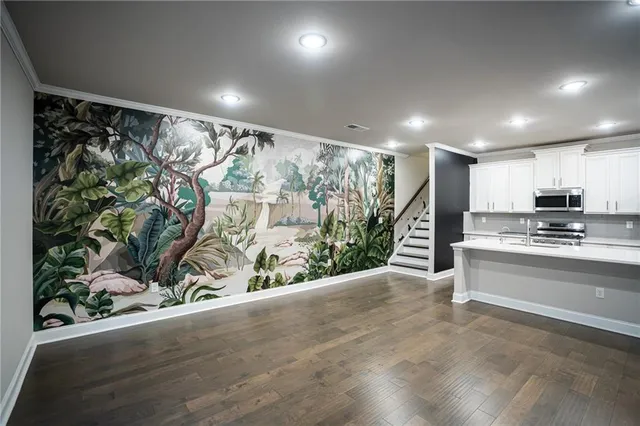 a view of kitchen with sink and refrigerator