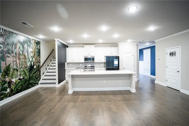 a view of an empty room with a fireplace and a window