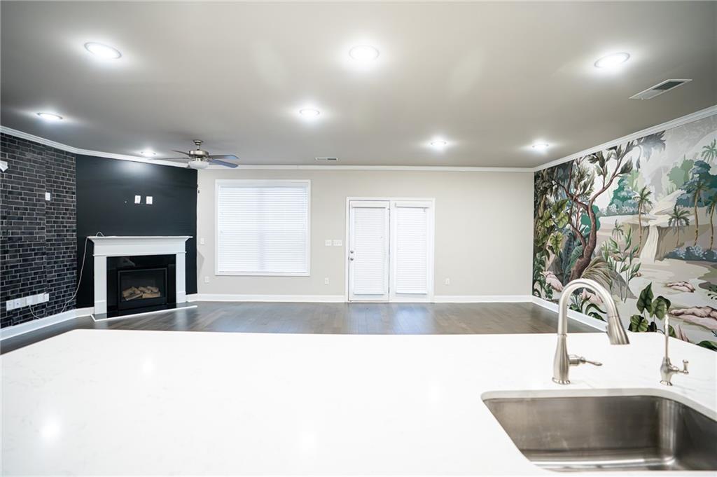 2215 A Manor Pointe Drive Cumming, GA 30041 - Photo 10 of 49 a view of a kitchen with a sink and a fireplace