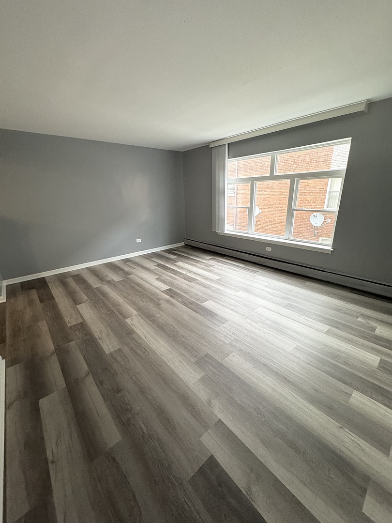 3642 147th Place Midlothian, IL 60445 - Photo 12 of 16 a view of an empty room with wooden floor and a window