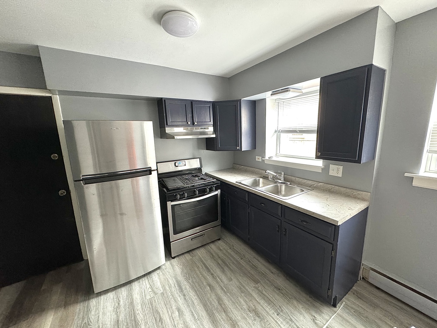 3642 147th Place Midlothian, IL 60445 - Photo 7 of 16 a kitchen with stainless steel appliances granite countertop a refrigerator stove a sink and a dishwasher with wooden floor