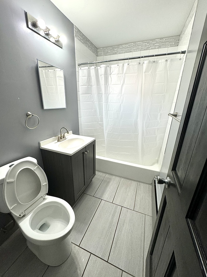 3642 147th Place Midlothian, IL 60445 - Photo 8 of 16 a bathroom with a toilet sink and mirror