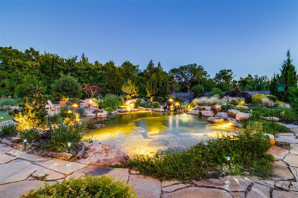 388 Bethany Road Sunnyvale, TX 75182 - Photo 2 of 40 A stunning natural swimming koi pond surrounded by lush landscaping and ambient lighting creates a peaceful, resort-style retreat