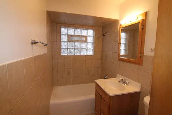 a bathroom with a sink toilet and tub