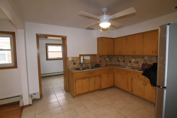 a kitchen with a sink cabinets and appliances