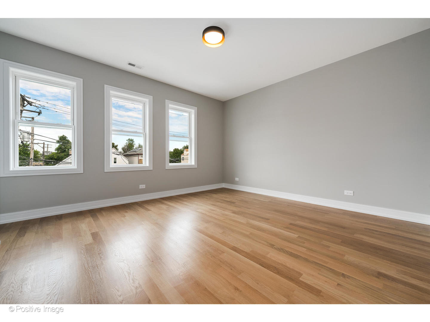 3107 North Oakley Avenue Chicago, IL 60618 - Photo 27 of 28 an empty room with wooden floor and windows