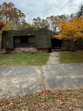 a view of yard with swimming pool and green space