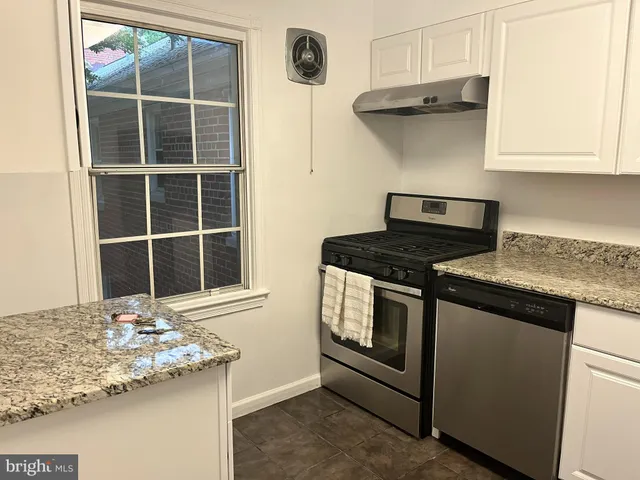 a kitchen with stainless steel appliances granite countertop a stove and a sink