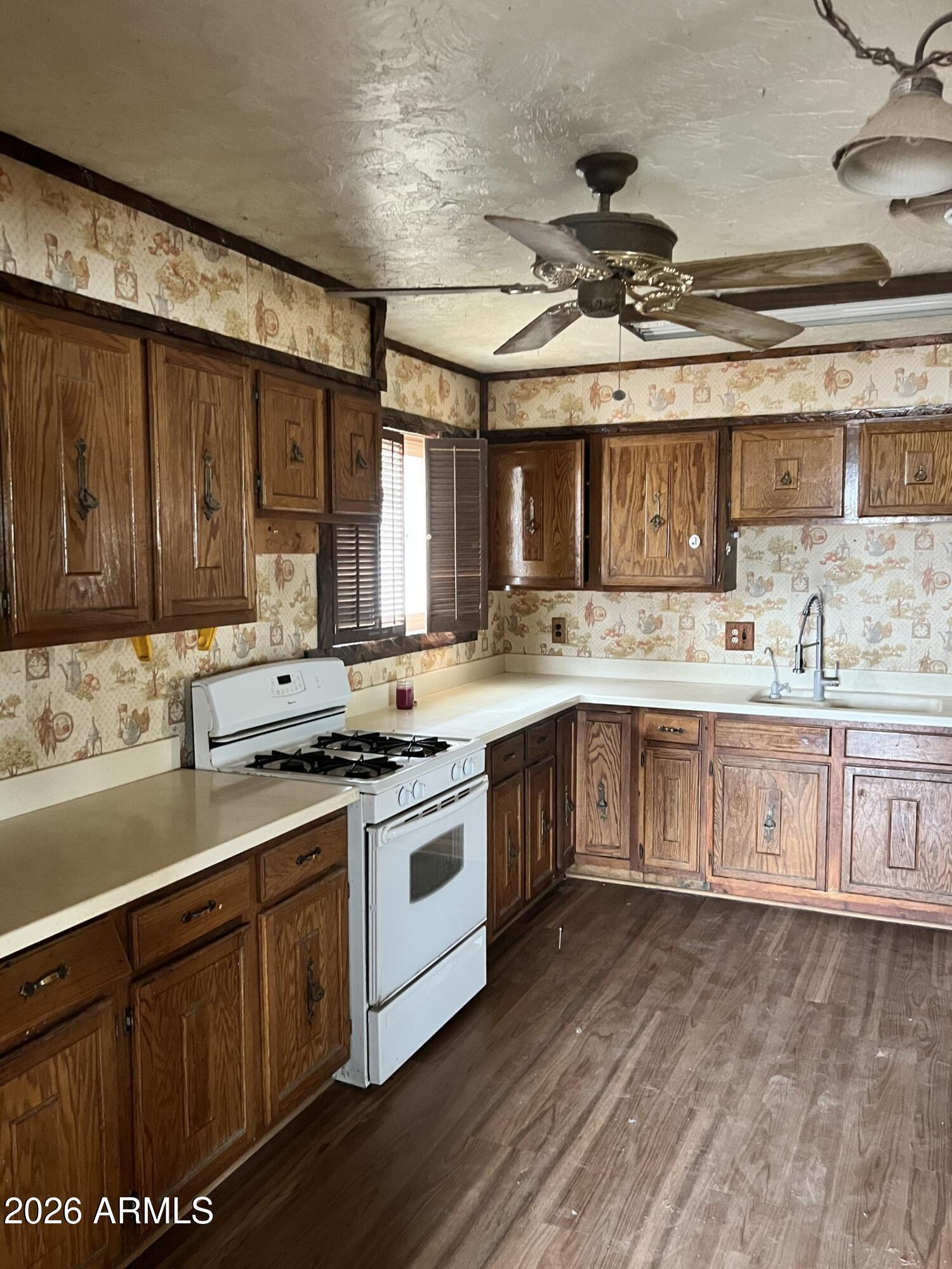 315 Fairhaven Road Kearny, AZ 85137 - Photo 7 of 9 a kitchen with a stove sink and cabinets