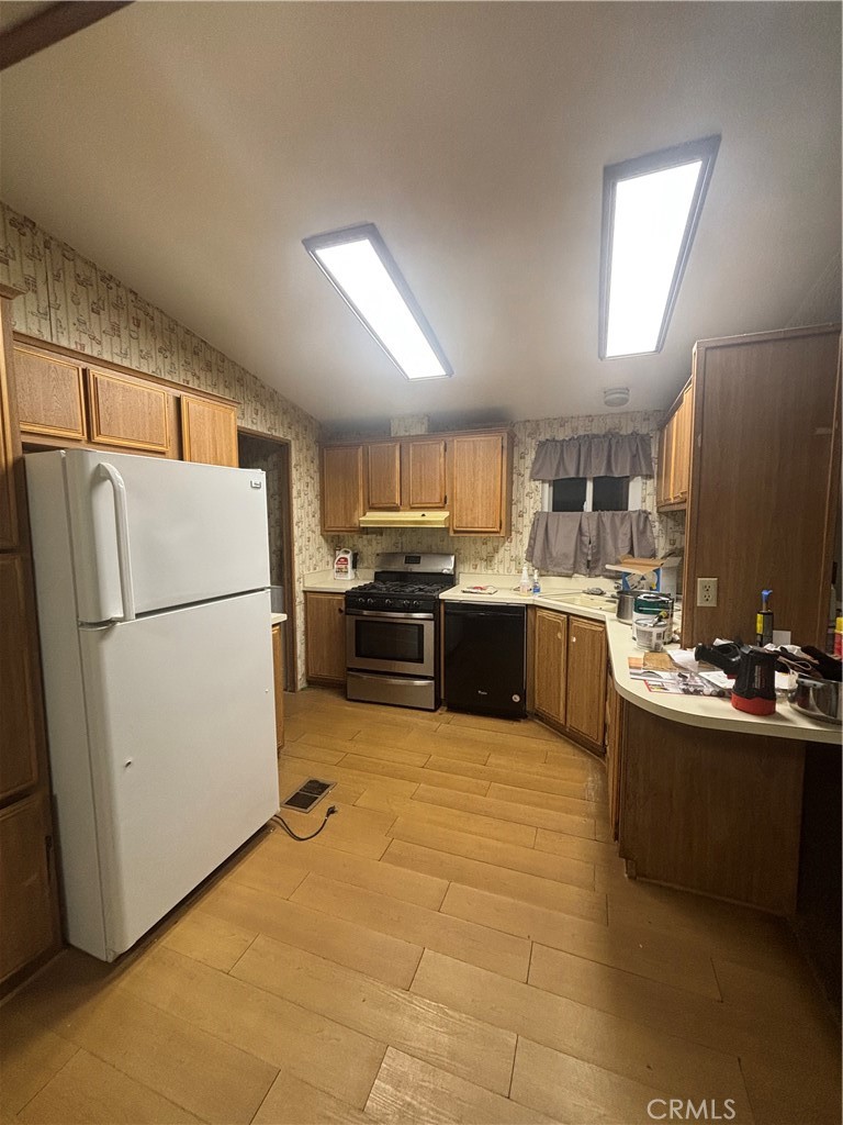22840 Cajalco Road Perris, CA 92570 - Photo 3 of 8 a kitchen with a refrigerator a sink and a stove