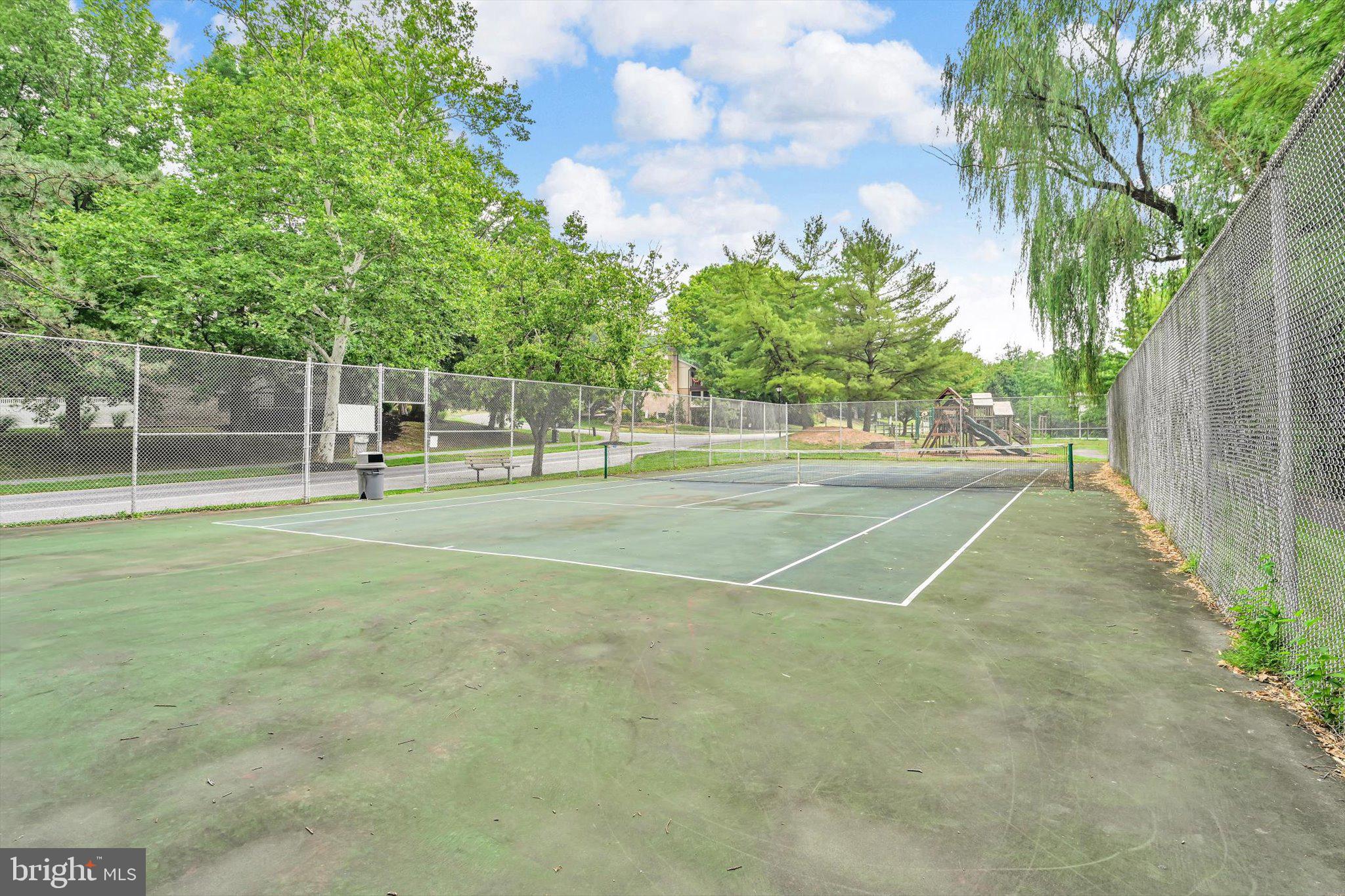 2 B Fairway Road Reading, PA 19607 - Photo 31 of 31 Serene tennis court in lush greenery.