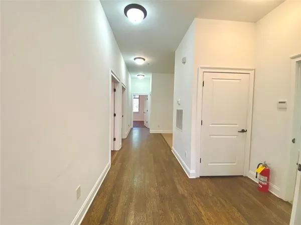 a view of a kitchen with a refrigerator and a stove top oven