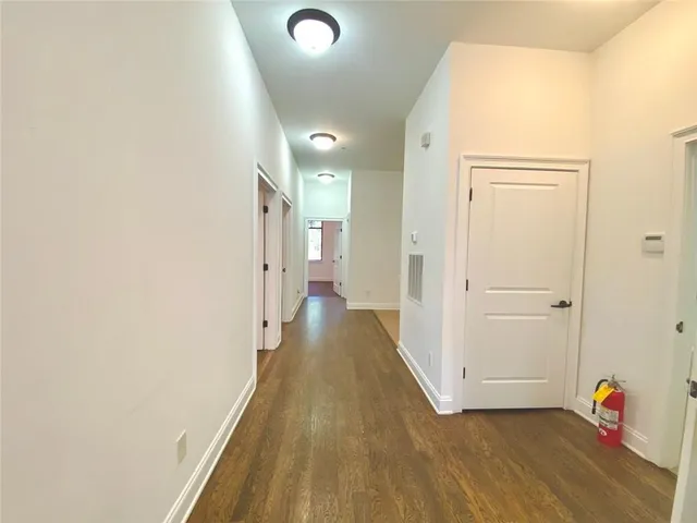a view of a kitchen with a refrigerator and a stove top oven