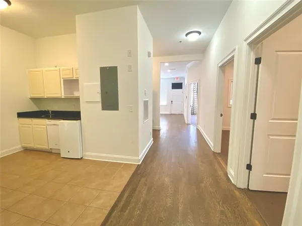 a kitchen with granite countertop white cabinets and white appliances