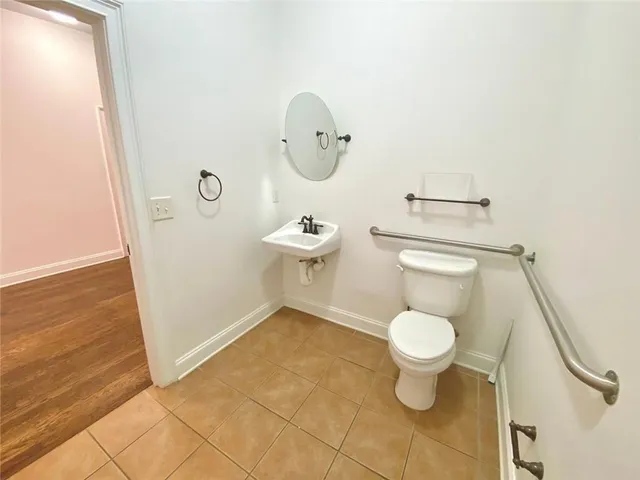 a bathroom with a sink a toilet and a mirror