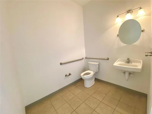 an empty room with windows and fireplace